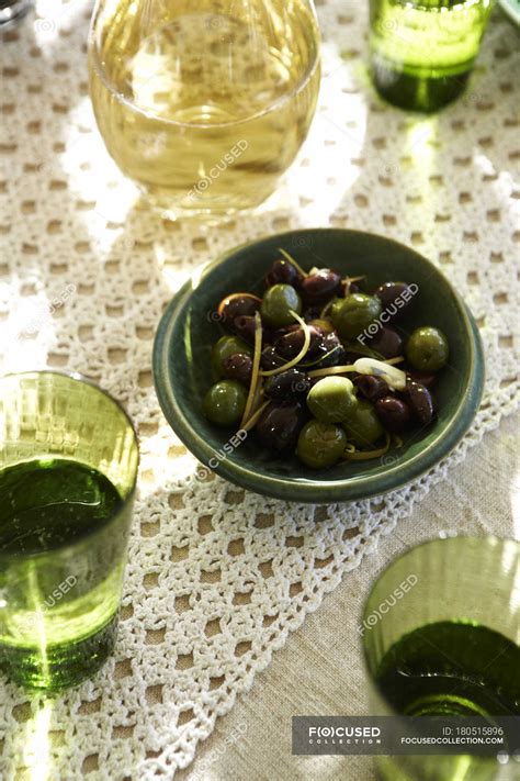 Top View Of Warmed Olives In Bowl With White Wine And Water — Indoors