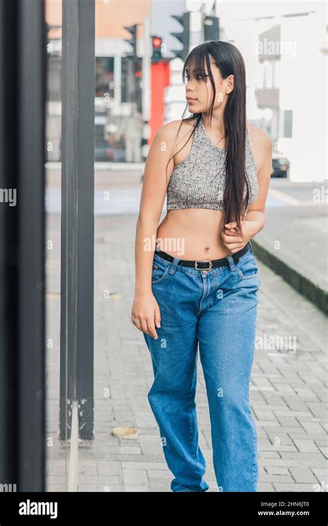 Beautiful Latina Brunette Woman Standing Next To A Mirror On The Street