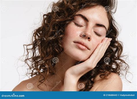 Half Naked Curly Woman Touching Her Face While Posing On Camera Stock