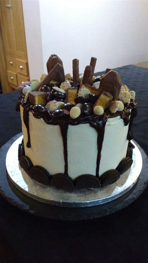 drip cake chocolate and vanilla cake filled vanilla buttercream dripped with chocolate ganache