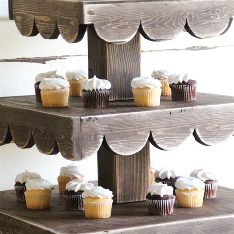 Try stacking mini favour bags or packets of seeds on a tall afternoon tea stand, or arrange a selection of pastel flowers on each tier. DIY Cupcake Stand - And a Giveaway | Rustic cupcake stands, Wooden tiered stand, Wooden cake stands