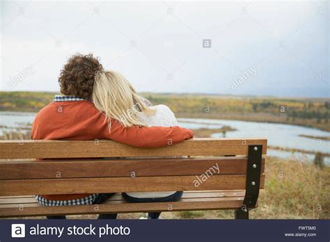 Two Women Sitting Side By Side On Park Bench Hi Res Stock Photography