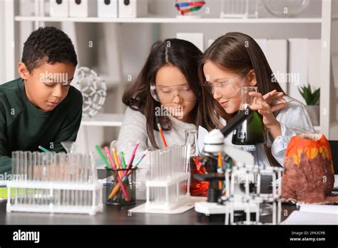 Little Children Conducting Chemistry Experiment In Science Classroom