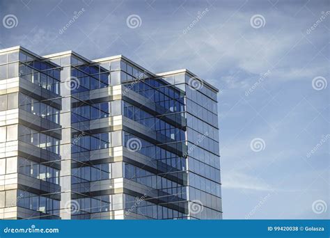 Modern Business Office Made From Glass Against Blue Sky Stock Photo