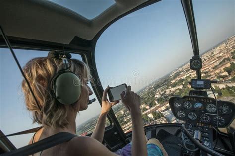 Portrait Of Beautiful Blonde Women And Pilot Enjoying Helicopter Flight