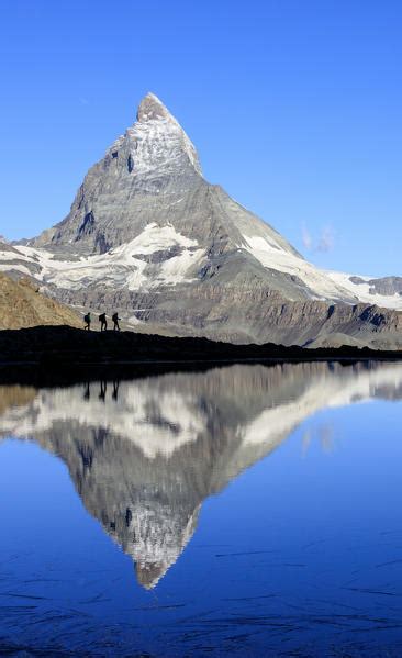 Lovers Admire Matterhorn Reflected In Lake Stellisee On A Starry Night