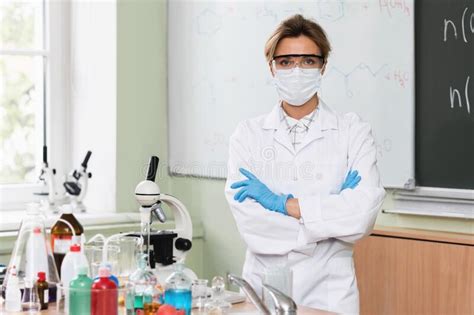 Scientist Wearing Mask Gloves And Protective Eyeglasses In A