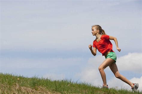 Austria Teenage Girl Running On Grass Stock Photo