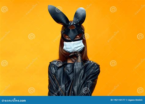 Female Rabbit Mask Posing Sexually In A Medical Mask From Coronavirus