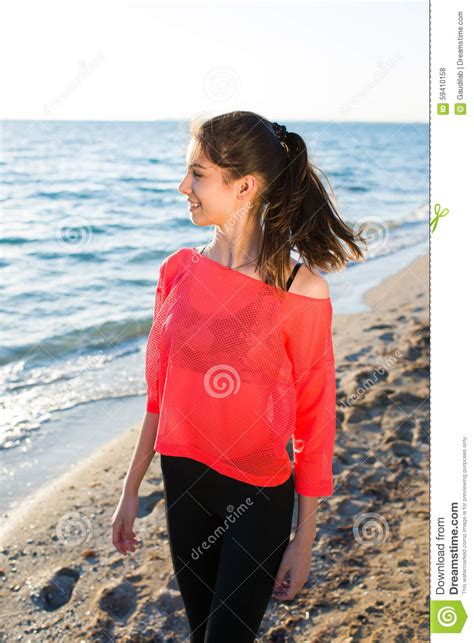 Gorgeous Female Runner Taking Break After Jogging On Beach Outdoors