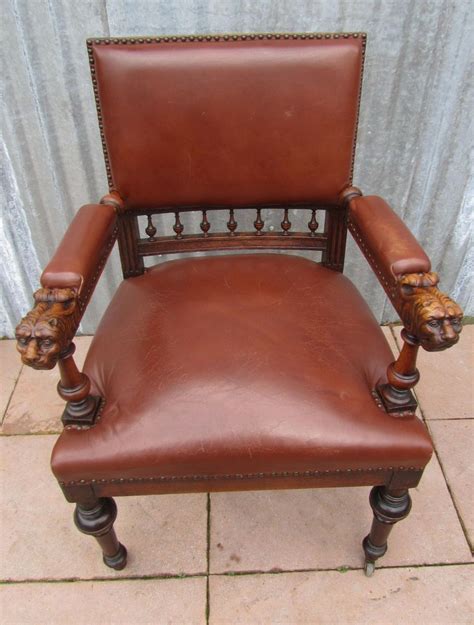 Seat and back are covered with black leather, and backrest has a tufted finish and silver nails as decorations. Antique Dutch Carved Oak Lion Head Arm Chair for sale at ...
