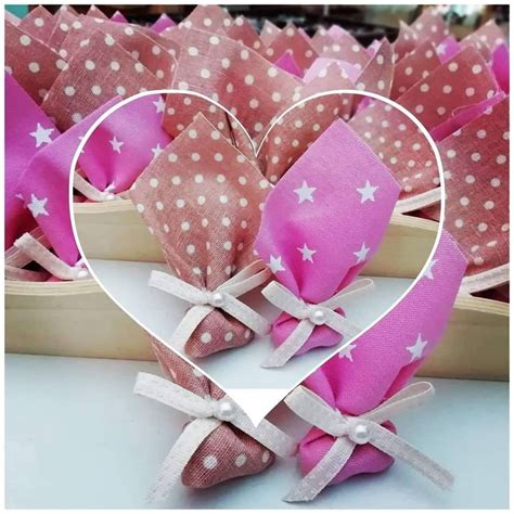 Pink And White Hearts With Stars On Them Are Sitting In Front Of Some