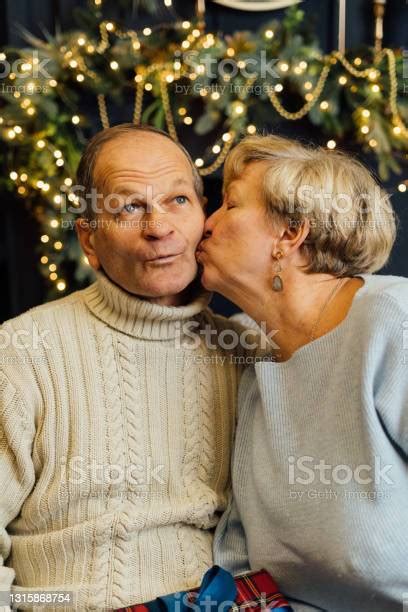 Portrait Of Old Couple Wife And Husband Hugging And Smiling Dark Blue