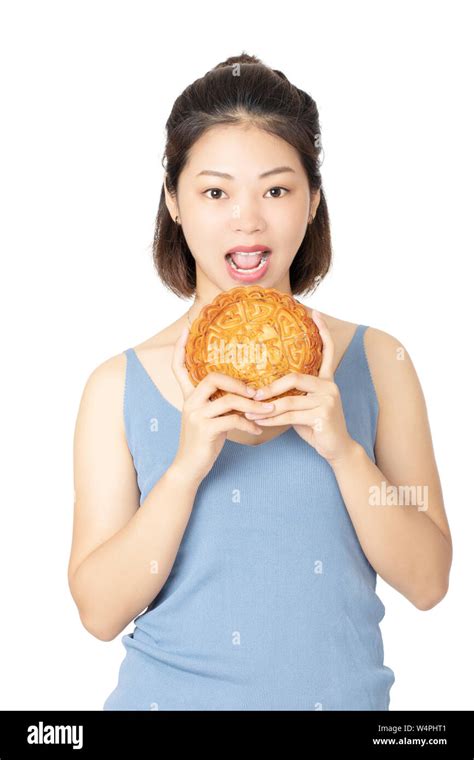 Beautiful Chinese Woman Dressed In Casual Clothes Holding A Moon Cake