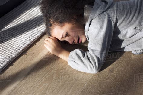 Girl Lying On Floor Crying Stock Photo Dissolve