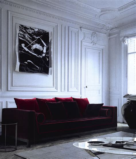 Few things feel more luxe than coming home to a sleek, cushy, velvet sofa. Maxalto red velvet sofa against vintage wall panelling ...