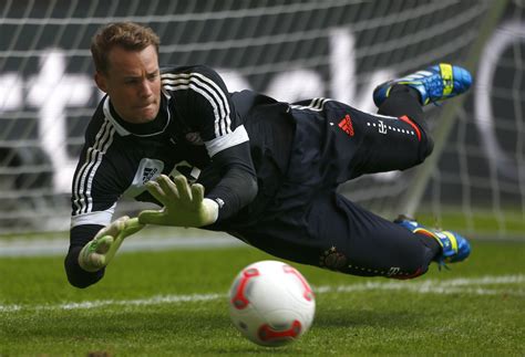 The Goalkeeper Of Bayern Manuel Neuer Is Catching A Ball Wallpapers And