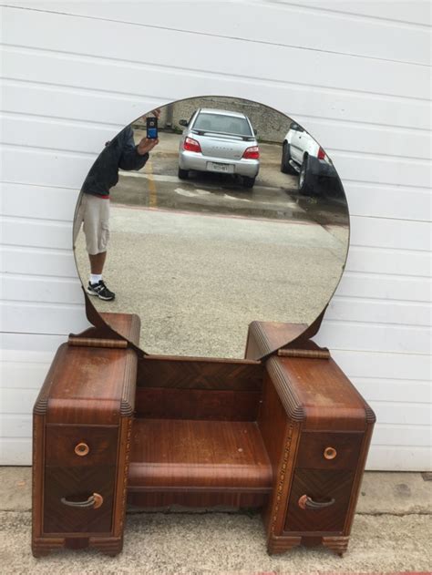 The claws that hold the mirror have cracked from age and need to be replaced, being held up by the green tape right. Antique wood four drawer vanity dresser with large round ...