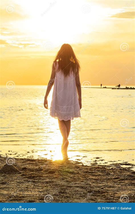 Girl Is Standing On The Beach At Sunset Background Stock Image Image