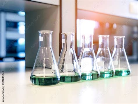The Erlenmeyer Or Conical Flasks On Bench Laboratory With Range Of