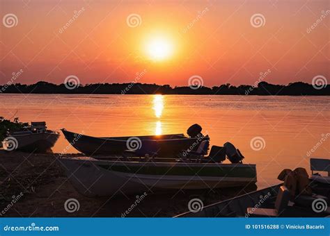 Silhouette Of Boats In Sunset Light With Island On Background Royalty