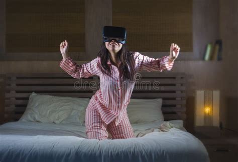 Happy And Excited Woman Playing With Virtual Reality Vr Goggles Headset Device Having Fun On Bed