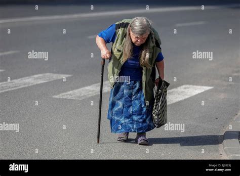 Elderly woman crossing a road in Chisinau, Moldova Stock Photo - Alamy
