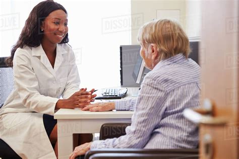 Senior Patient Having Consultation With Doctor In Office Stock Photo Dissolve