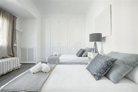 Bedroom With Single Beds Dark Wooden Floor Blue And Gray Cushions