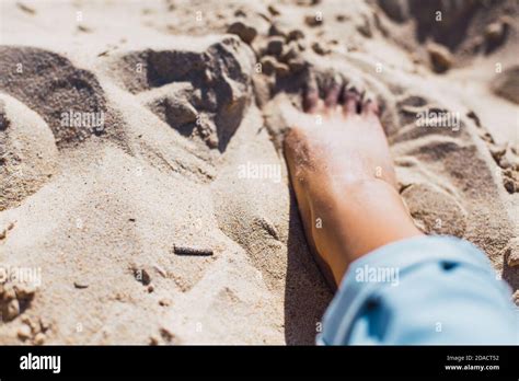 Woman Tanned Legs On Sand Beach Travel Concept Stock Photo Alamy