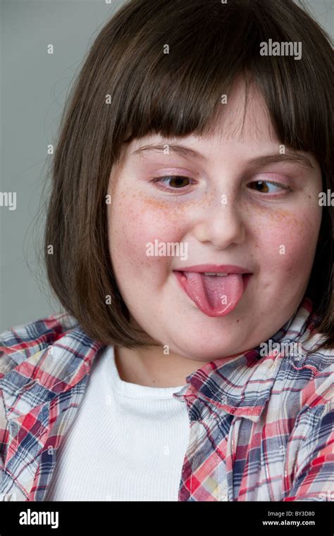 Close Up Portrait Of Young Girl Pulling Faces With Her Tongue Out And