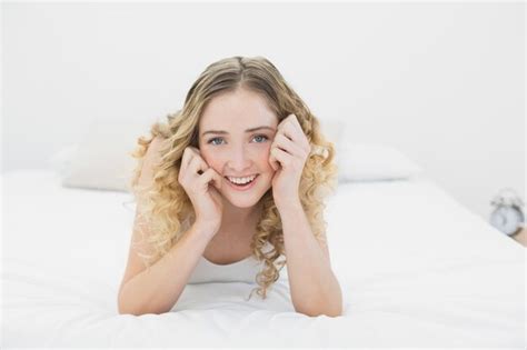 Premium Photo Pretty Lucky Blonde Lying On Bed Looking At Camera
