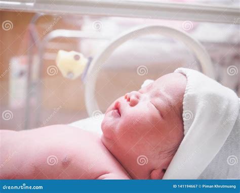 Newborn Baby Inside Incubator In Hospital Post Delivery Room Stock