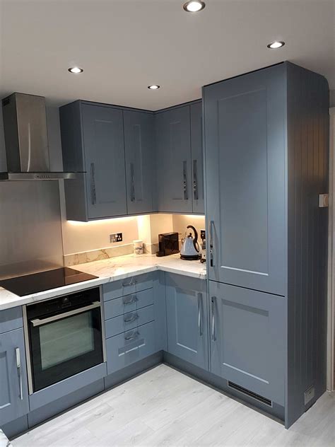 Shaker cabinets have remained a popular choice among homeowners for centuries, as they can pick a year, any year; Blue Shaker Kitchen Installation - Hallmark Kitchen Designs