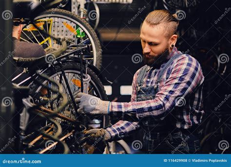 Mechanic Doing Bicycle Wheel Service Manual In A Workshop Stock Photo