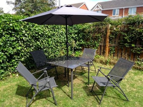 Garden table with parasol, x4 accompanying chairs | in Durham, County