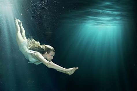 girl diving into large underwater black by zena holloway