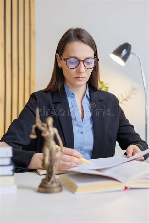 Female Lawyer In Strict Suit Works In Office Or Court Checks Clients