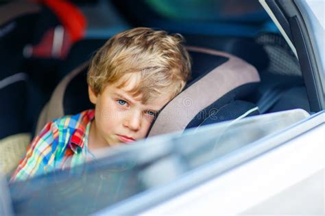 Sad Tired Kid Boy Sitting In Car During Traffic Jam Stock Photo Image