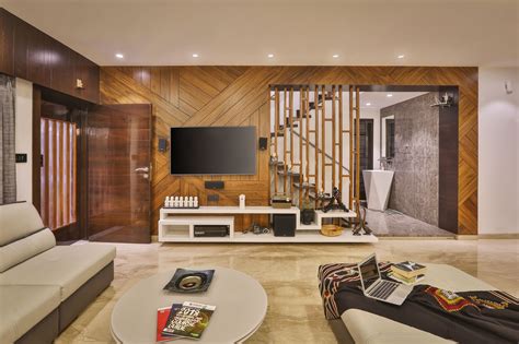 A Living Room With White Furniture And Wooden Walls