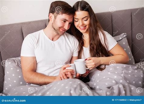 Intimate Sensual Young Couple In Bedroom Enjoying Each Other Stock