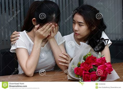 Stressed Young Asian Woman Supporting Depressed Crying Female Friend In