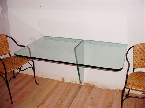 This glass coffee table by greyson living features a raised, mirrored base and a smoked glass top that combine to form an elegant look. Floating Glass Table - Marc Konys Glass Design