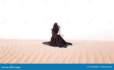 A Woman In Abaya Sitting In The Desert Stock Image Image Of Copy