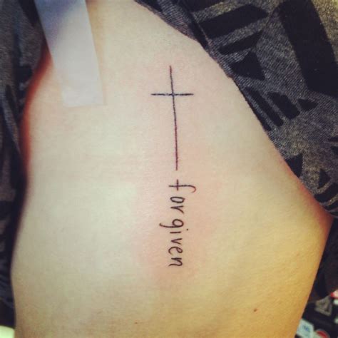 Forgiveness and loyalty are common themes in tattooing. Love the length of this cross. No words, just the cross on ...