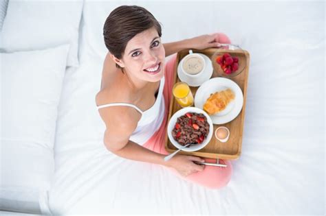 Premium Photo Happy Brunette Having Her Breakfast In Bed