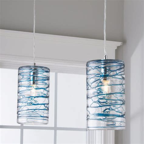 light patterns dance on the walls and ceiling from the swirling patterns on this blown glass