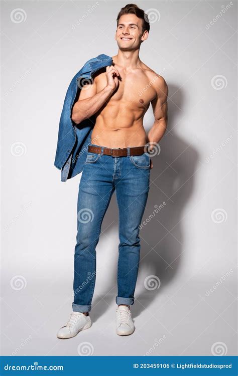 Cheerful Shirtless Man Holding Denim Shirt Stock Photo Image Of