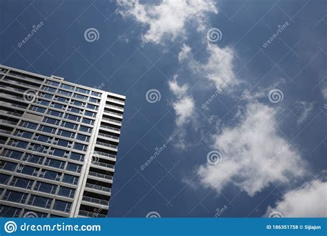 Skyscrapers Under A Sunny Blue Sky And White Clouds Stock Photo Image