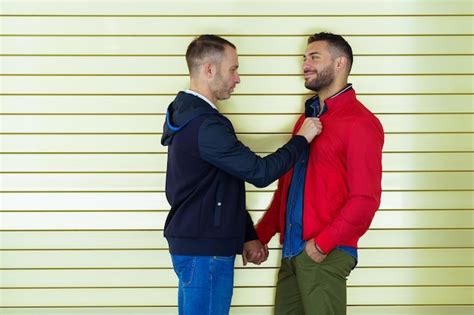 Premium Photo Smiling Gay Couple Standing Against Wall Outdoors